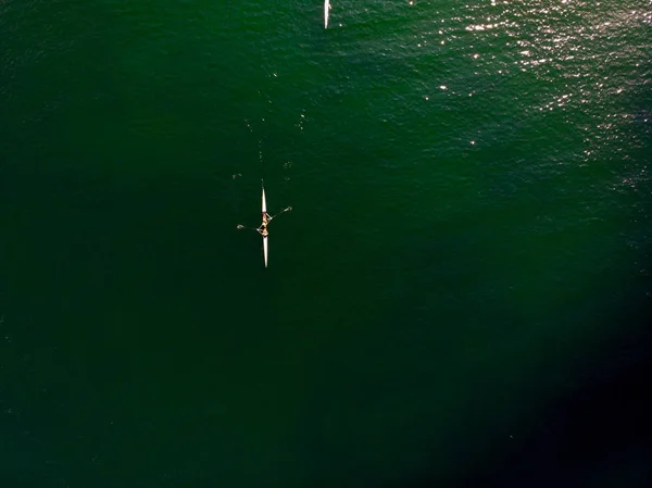 Aerial Drone View of Rowing Team with Canoe in Tranquil Sea / Birds Eye View. Sports in Nature