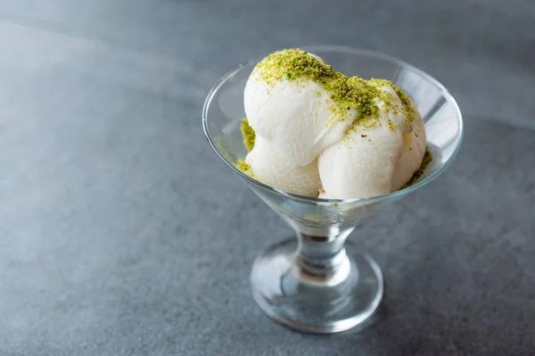 Turkish Maras Vanilla Ice Cream with Pistachio Powder Served Portion in Glass Cup. Traditional Organic Summer Dessert.