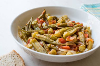Domates ve soğan dilimleri ile yemek bamya yemek / Bamya. Geleneksel organik gıda.