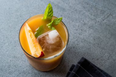 Şeftali Bourbon kokteyl şeftali dilim, nane yaprakları ve buz yaz İçecek ile.