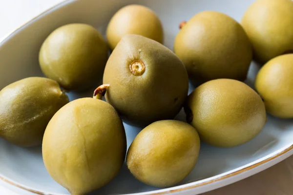 Pickled Unripe Green Almond Pickles in Plate / Cagla Badem. Organic Food.