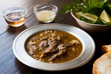 Turkish Soup Beyran with Lamb Meat, Rice, Chopped Garlic and Vinegar Sauce Served with Salad. Traditional Organic Food. clipart