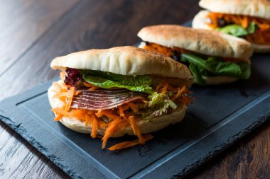 Tayvan'ın pide ekmek Bun sandviç Gua Bao Füme pastırma, havuç dilimleri ve Yeşiller Asya'dan. Geleneksel organik gıda.