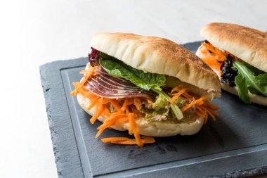 Tayvan'ın pide ekmek Bun sandviç Gua Bao Füme pastırma, havuç dilimleri ve Yeşiller Asya'dan. Geleneksel organik gıda.