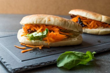 Vegan / Vejetaryen pide ekmek Bun sandviç Tayvan'ın Gua Bao havuç dilimleri ve yeşillik Asya ile. Geleneksel organik gıda.