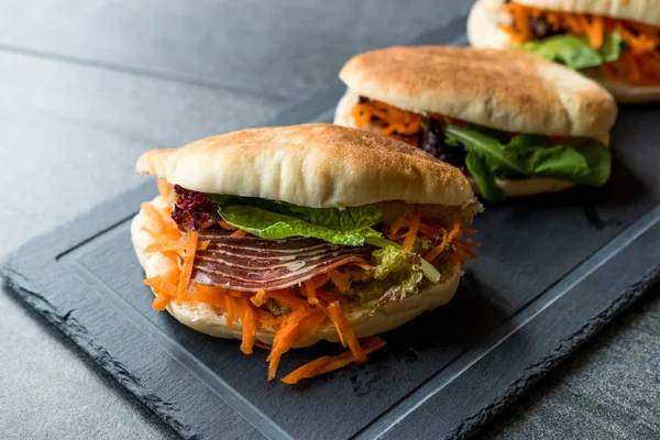 Taiwan\'s Pita Bread Bun Sandwich Gua Bao with Smoked Bacon, Carrot Slices and Greens from Asia. Traditional Organic Food.