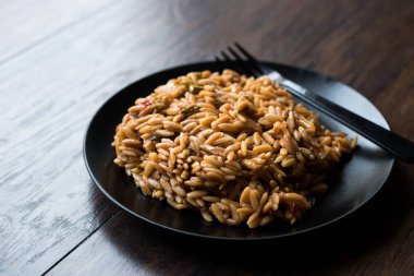 Türk usulü pişmiş siyah plaka Orzo Makarna / Pilav veya pilav. Organik gıda.