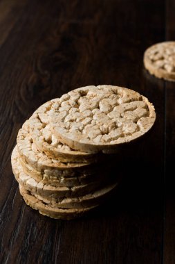 Bulgur pirinç kek kraker boyunca koyu ahşap yüzeyde şeklinde. Organik meze cips.