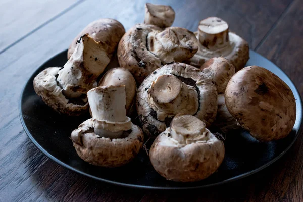 Portobello Raw Cremini Mushrooms in Black Plate. Organic Food.