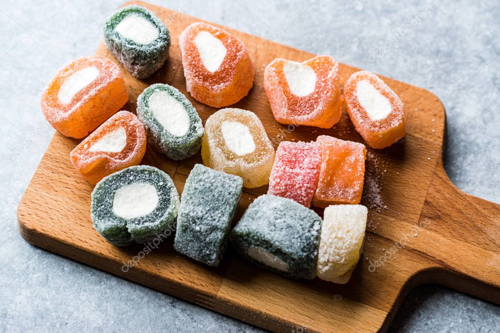 Fruity Turkish Delight Roll Shaped on Wooden Board. Traditional Dessert.