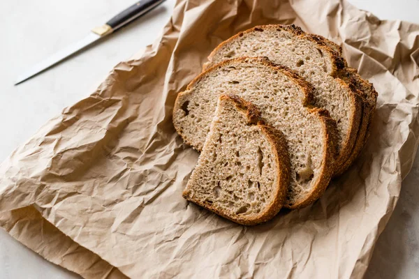 Artisan Sliced Homemade Sourdough Bread Slices with Paper Bag / Package or Craft Paper. Organic Bakery Food.