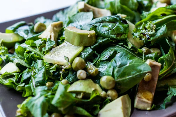 Avocado Salad with Green Peas and Rocket Leaves in Rectangular Plate / Arugula or Rucola Leaves. Organic Fresh Food.