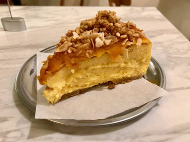 Kabak Cheesecake dilim kızarmış fındık ve badem ile hizmet Gümüş plaka ile kahve dükkanında / Cafe Shop. Organik tatlı.
