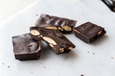 Bitter Almond Chocolate Pieces on White Marble Surface. Organic Snacks.