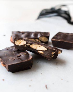 Bitter Almond Chocolate Pieces on White Marble Surface. Organic Snacks.