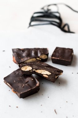 Bitter Almond Chocolate Pieces on White Marble Surface. Organic Snacks.