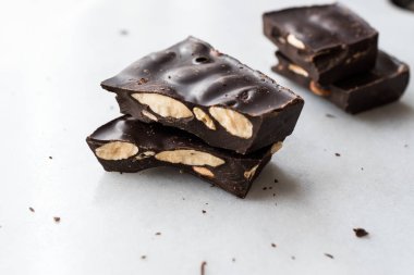 Bitter Almond Chocolate Pieces on White Marble Surface. Organic Snacks.