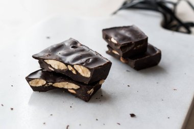 Bitter Almond Chocolate Pieces on White Marble Surface. Organic Snacks.