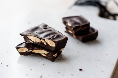 Bitter Almond Chocolate Pieces on White Marble Surface. Organic Snacks.