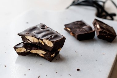 Bitter Almond Chocolate Pieces on White Marble Surface. Organic Snacks.