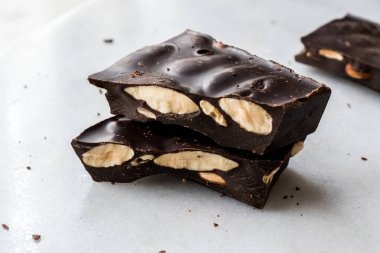 Bitter Almond Chocolate Pieces on White Marble Surface. Organic Snacks.