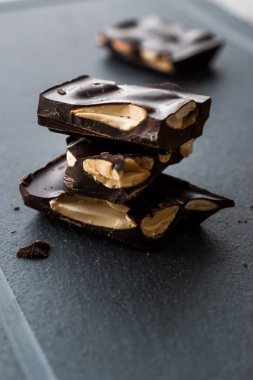 Acı badem çikolata parçaları karanlık mermer yüzey. Organik aperatifler