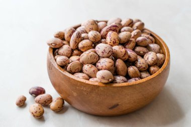 Raw Dry Pinto Beans on Marble Board with Wooden Bowl / Kidney Beans. Organic Food.