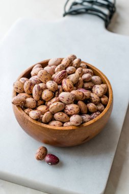 Raw Dry Pinto Beans on Marble Board with Wooden Bowl / Kidney Beans. Organic Food.