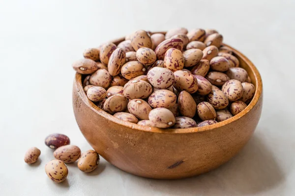 Raw Dry Pinto Beans on Marble Board with Wooden Bowl / Kidney Beans. Organic Food.
