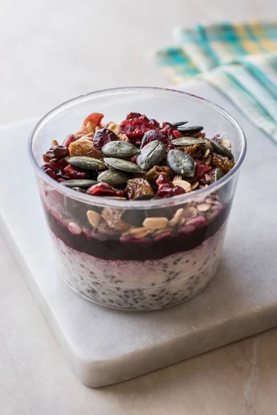 Healthy Chia Pudding Yogurt with Pumpkin Seeds and Granola / Acai Bowl in Plastic Cup. Organic Dessert.