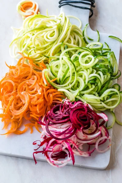 Spiralized Vegetables Noodle Carrot, Beetroot, Zucchini and Cucumber on Marble Board. Organic Food.
