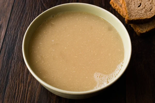 Wheat Soup with Chicken Broth Bouillon on Dark Wooden Surface. Organic Food. — Stock Image Wheat Soup Chicken Broth Bouillon Dark Wooden Surface Organic Food Royalty Free Stock Photos