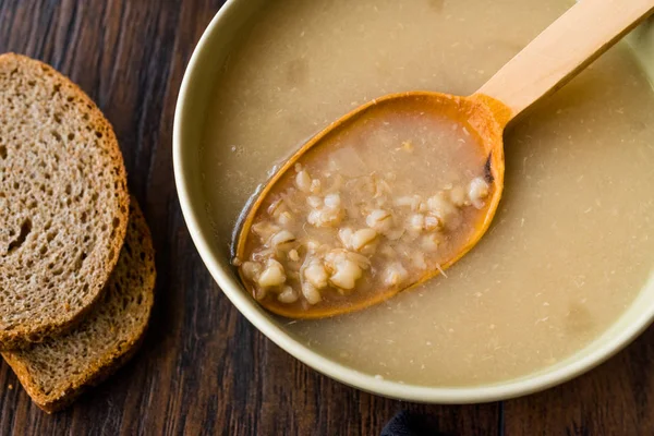 Wheat Soup with Chicken Broth Bouillon on Dark Wooden Surface. Organic Food. — Stock Image Wheat Soup Chicken Broth Bouillon Dark Wooden Surface Organic Food Royalty Free Stock Images