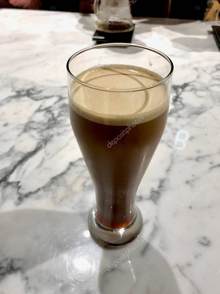 Glass of Nitro Cold Brew Coffee on Marble Surface Ready to Serve