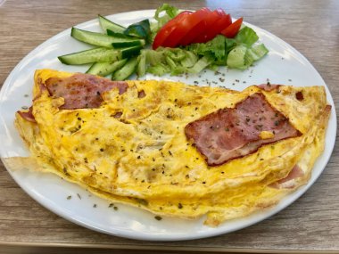 Salatalık ve domates ile servis pastırmalı omlet.