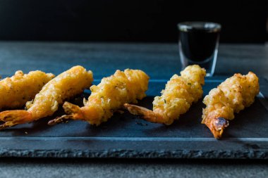 Siyah taş tahta üzerinde Soya soslu karides Tempura.