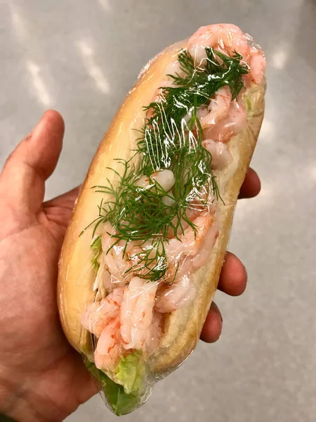 Shrimp Sandwich with Stretch Film Holding in Hand.