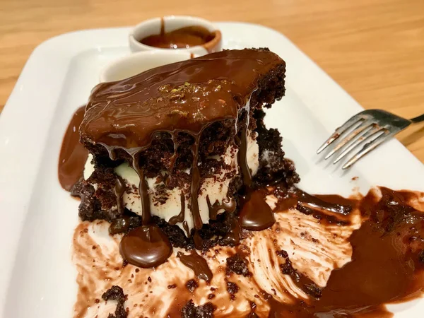 Flowing Chocolate Sauce from the Cake with Ice Cream / Brownie