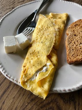 Kahvaltı için tost ekmeğiyle sarılı krem peynirli omlet..
