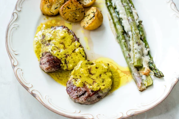 Tenderloin Meat with Cafe De Paris Sauce with Asparagus and Baked Potatoes in Plate Ready to Serve.