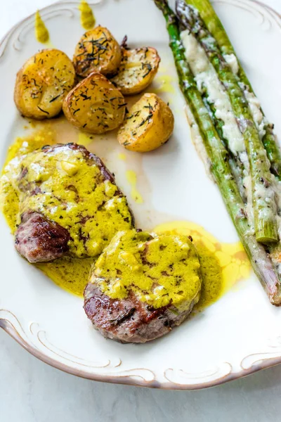 Tenderloin Meat with Cafe De Paris Sauce with Asparagus and Baked Potatoes in Plate Ready to Serve.