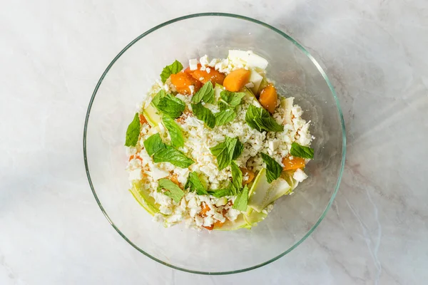 Insalata di zucchine e albicocche con formaggio e foglie di menta pronte da mescolare prima di mangiare . — Foto Stock