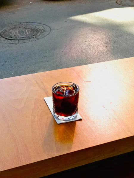 Cold Brew Coffee with Ice or Iced Coffee at Cafe Shop on Wooden Surface.