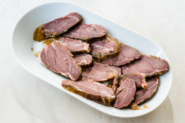 Smoked Meat Veal Cheek Slices on Wooden Board. Ready to Eat.