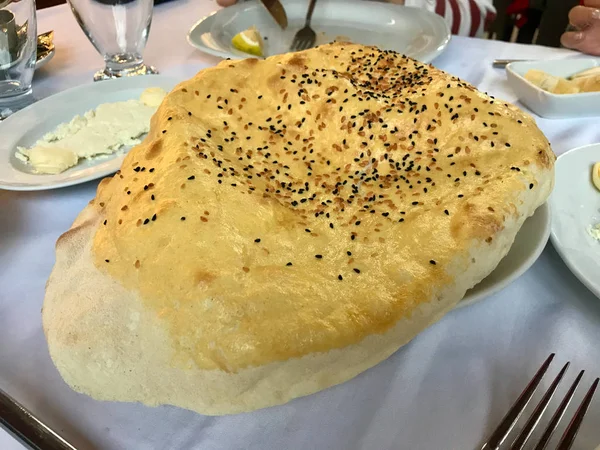 Turkish Flat Bread Pide Lavash with Black Cumin Sesame Seeds at Local Kebab Restaurant.