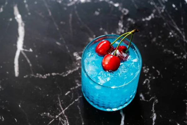 Blue Lagoon Cocktail with Cherries and Crushed Ice. Ready to Drink.