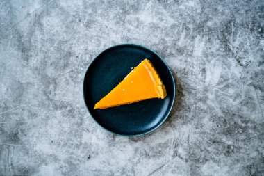 Balkabağı turtası, Şükran Günü için yapılan tart ve buğday unu siyah tabakta. Gri taş arka plan. Hizmet ve Yemeye Hazır.