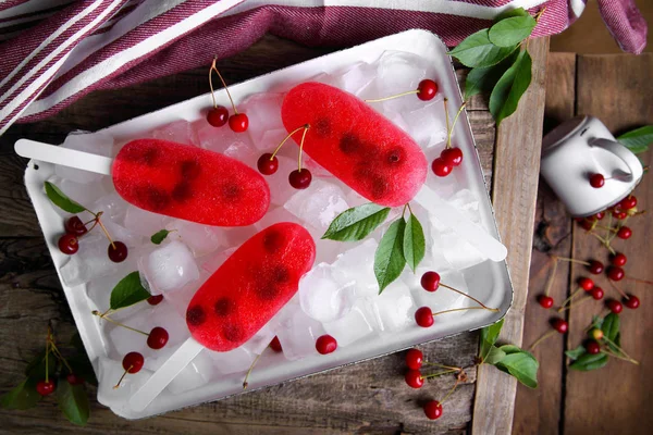 cherry ice cream with fresh berries on ice cubes