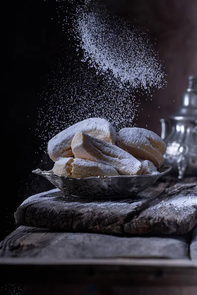 biscuits with icing sugar in a silver plate