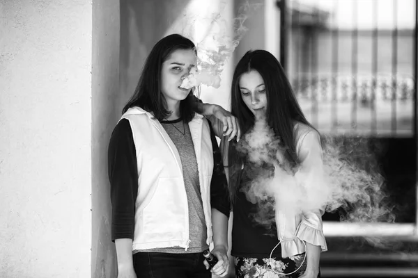 Vape Adolescentes Duas Jovens Meninas Bonitos Roupas Casuais Fumam Cigarros — Fotografia de Stock